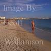 GW19525-50 = Late afternoon view - lady strolling along waters edge - looking East along Playa de Palma ( Platja de Palma ) beach, Palma de Mallorca, Balearic Islands, Spain. 