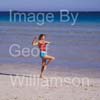 GW31670-60 = Young lady undertaking Tai Chi and fitness exercises on a beach in Mallorca, Spain.