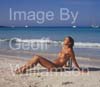 GW34975-60 = Young nude lady enjoying sun, sea and sand on Es Trenc beach( with boats at anchor behind ) in SE Mallorca / Majorca, Balearic Islands, Spain.  17th August 2009. Model Release.