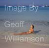 GW35005-60 = Young nude lady enjoying sun, sea and sand on Es Trenc beach( with boats at anchor behind ) in SE Mallorca / Majorca, Balearic Islands, Spain.  17th August 2009. Model Release.