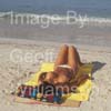 GW35061-60 = Young topless lady enjoying sun, sea and sand on Es Trenc beach in SE Mallorca / Majorca, Balearic Islands, Spain.  17th August 2009. Model Release.