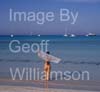 GW35140-60 = Young nude lady enjoying sun, sea and sand at Es Trenc beach ( with boats at anchor behind ) in SE Mallorca / Majorca, Balearic Islands, Spain.  17th August 2009. Model Release.